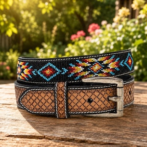 May include: A belt featuring a black section adorned with a multi-colored geometric beaded pattern and a tan leather section with a stamped basketweave texture. The belt includes a silver-toned metal buckle and white stitching along the edges.