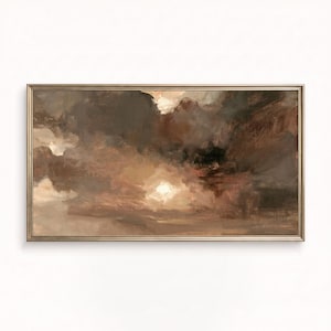 May include: A rectangular landscape painting in a metallic frame featuring abstract, thick brushstrokes in shades of dark brown, taupe, cream, and muted gray. The composition depicts a cloudy, atmospheric sky with a bright, central light source.
