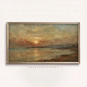 May include: An oil painting of a sunset over a body of water, framed in a gold-colored rectangular frame. The artwork features warm colors, including orange, yellow, and brown, with a hint of blue in the sky. The text "UKATSDIGITALART" is visible at the bottom.