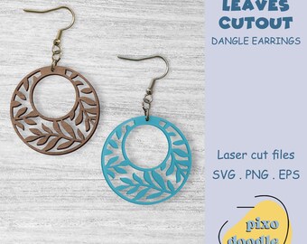 May include: Two dangle earrings with leaf cutouts. One earring is brown, the other is turquoise. The earrings have a circular design with a leaf pattern cut out. The text "LEAVES CUTOUT DANGLE EARRINGS" is visible.