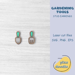 May include: A pair of wooden stud earrings featuring a turquoise blue trowel and a turquoise blue garden fork. The earrings are on a white wood background. The text "GARDENING TOOLS STUD EARRINGS" is in the upper right corner of the image. The text "Laser cut files SVG. PNG. EPS" is in the lower right corner of the image. The text "pixo doodle" is in the lower right corner of the image.