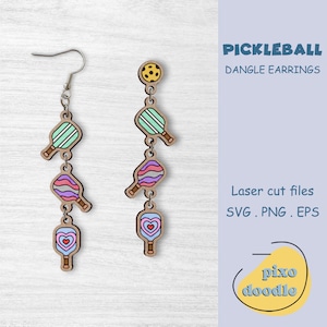 May include: A pair of dangle earrings featuring a pickleball theme. Each earring has four charms: a pickleball, a paddle with a heart, a striped paddle, and a paddle with a swirl pattern. The earrings are made of wood and have a laser-cut design. The text "PICKLEBALL DANGLE EARRINGS" is visible in the image. The text "Laser cut files SVG. PNG. EPS" is also visible in the image.