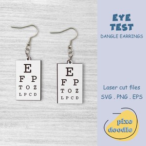 May include: A pair of dangle earrings with a white eye chart design. The earrings are made of silver metal and have a simple hook closure. The eye chart features the letters E, FP, TOZ, and LPCD. The earrings are labeled "Eye Test Dangle Earrings".
