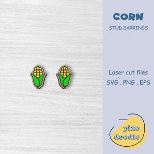 May include: A pair of wooden stud earrings featuring a cartoon corn cob design. The corn is yellow with green leaves. The earrings are laser cut and come in SVG, PNG, and EPS file formats. The text "CORN STUD EARRINGS" is visible in the image. The text "pixo doodle" is also visible in the image.