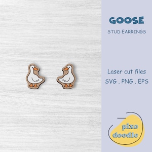 May include: A pair of wooden goose stud earrings. The geese are white with orange beaks and feet. The earrings are laser cut and come with SVG, PNG, and EPS files. GOOSE STUD EARRINGS.