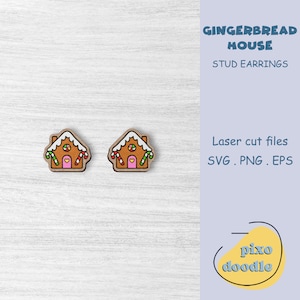 May include: A pair of gingerbread house stud earrings. The earrings are made of wood and are painted to look like gingerbread houses. The houses have white icing, red candy canes, and a pink door with a heart.