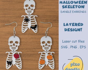 May include: A pair of white skeleton dangle earrings with layered designs. The earrings feature a skull with a ribcage and different Halloween-themed charms, including a spider, bat, heart, and pumpkin. The text "HALLOWEEN SKELETON DANGLE EARRINGS LAYERED DESIGN! Laser cut files SVG. PNG. EPS pίκο doodle" is visible in the image.