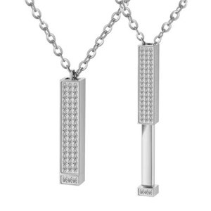 May include: Two silver necklaces with a rectangular pendant covered in small, clear stones. The pendant on the right necklace is open, revealing a silver bar inside.
