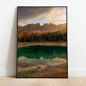 May include: A scenic photograph of a mountain lake with a reflection of the surrounding mountains in the water. The lake is surrounded by a forest of pine trees and the mountains are covered in a mix of green and brown foliage.