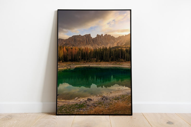 May include: A scenic photograph of a mountain lake with a reflection of the surrounding mountains in the water. The lake is surrounded by a forest of pine trees and the mountains are covered in a mix of green and brown foliage.