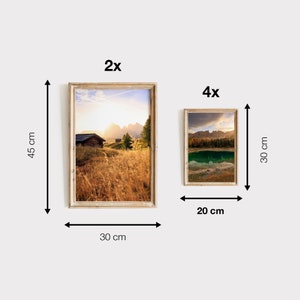 May include: Two framed landscape photographs, one is 30 inches by 45 inches and the other is 20 inches by 30 inches. The larger photo shows a wooden cabin in a field with mountains in the background. The smaller photo shows a lake with mountains in the background.