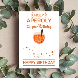 Weiß Geburtstagskarte mit dem Spruch: Holy Aperoly it's your Birthday - HAPPY BIRTHDAY, der Text ist Orange. In der Mitte ist eine Aperolglas abgebildet.