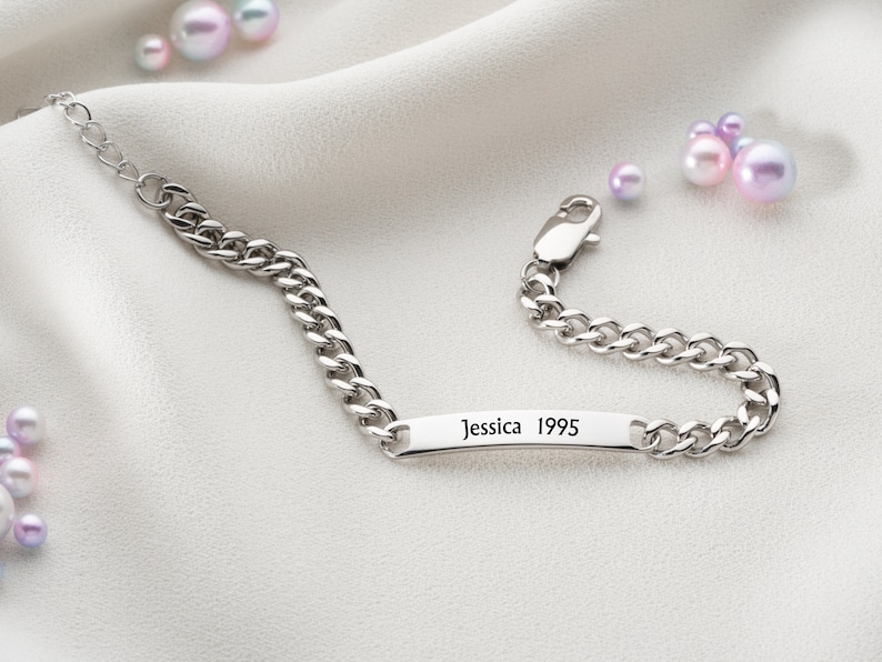 May include: Silver chain bracelet with a personalized nameplate that reads "Jessica 1995".