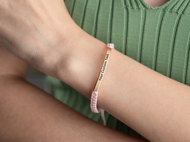 May include: A pink and gold bracelet with a personalized message that reads "Your Custom Text".