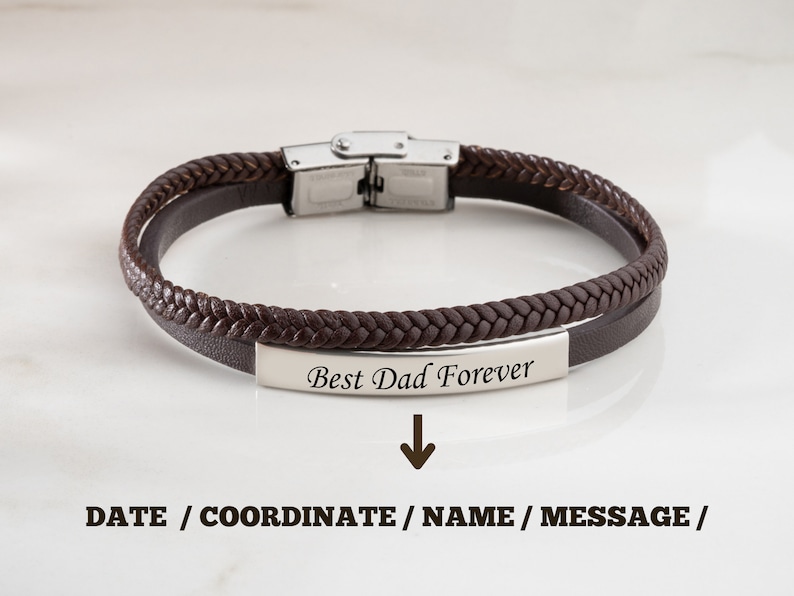 May include: Brown leather bracelet with a silver clasp and a silver plate engraved with the text "Best Dad Forever".