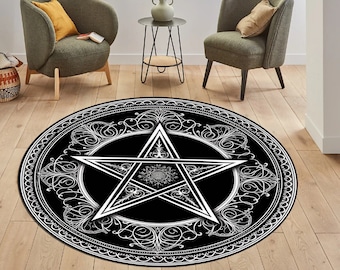 May include: A black and white round rug with a pentagram design. The pentagram is surrounded by a decorative border of swirling lines. The rug is on a wooden floor.