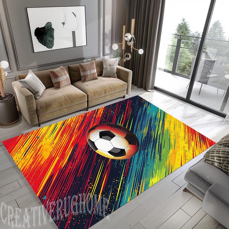 Puede incluir: Una alfombra colorida con fondo negro y un bal&oacute;n de f&uacute;tbol blanco en el centro. La alfombra tiene rayas de pintura roja, amarilla, azul y verde.