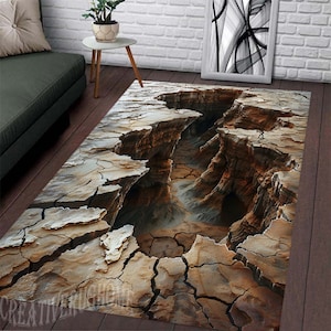 May include: A 3D printed rug with a cracked earth design. The rug features a deep canyon with brown, tan, and grey tones.