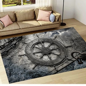 May include: A gray and white rug with a large ship's wheel design. The wheel is made of wood and has a rope wrapped around it. The rug also features a chain and anchor design.