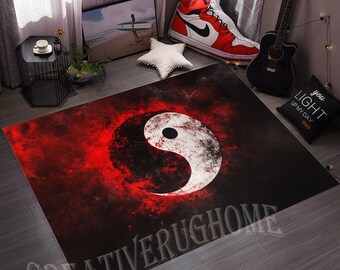 May include: A rectangular rug with a yin and yang design in white and black on a red and black backdrop. The rug has the text "CREATIVERUGHOME" at the bottom. It is placed on a wooden floor.