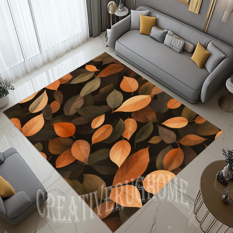 May include: A rectangular area rug featuring a pattern of autumn leaves in shades of brown, orange, and green against a dark background. The rug is placed on a tiled floor, with a sofa and other furniture visible in the background. The text "CREATIVERUGHOME" is visible.
