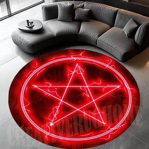 May include: A round red rug featuring a glowing white pentagram design. The rug has a textured appearance with a dark red background and a white circular border. The rug is placed on a gray floor.