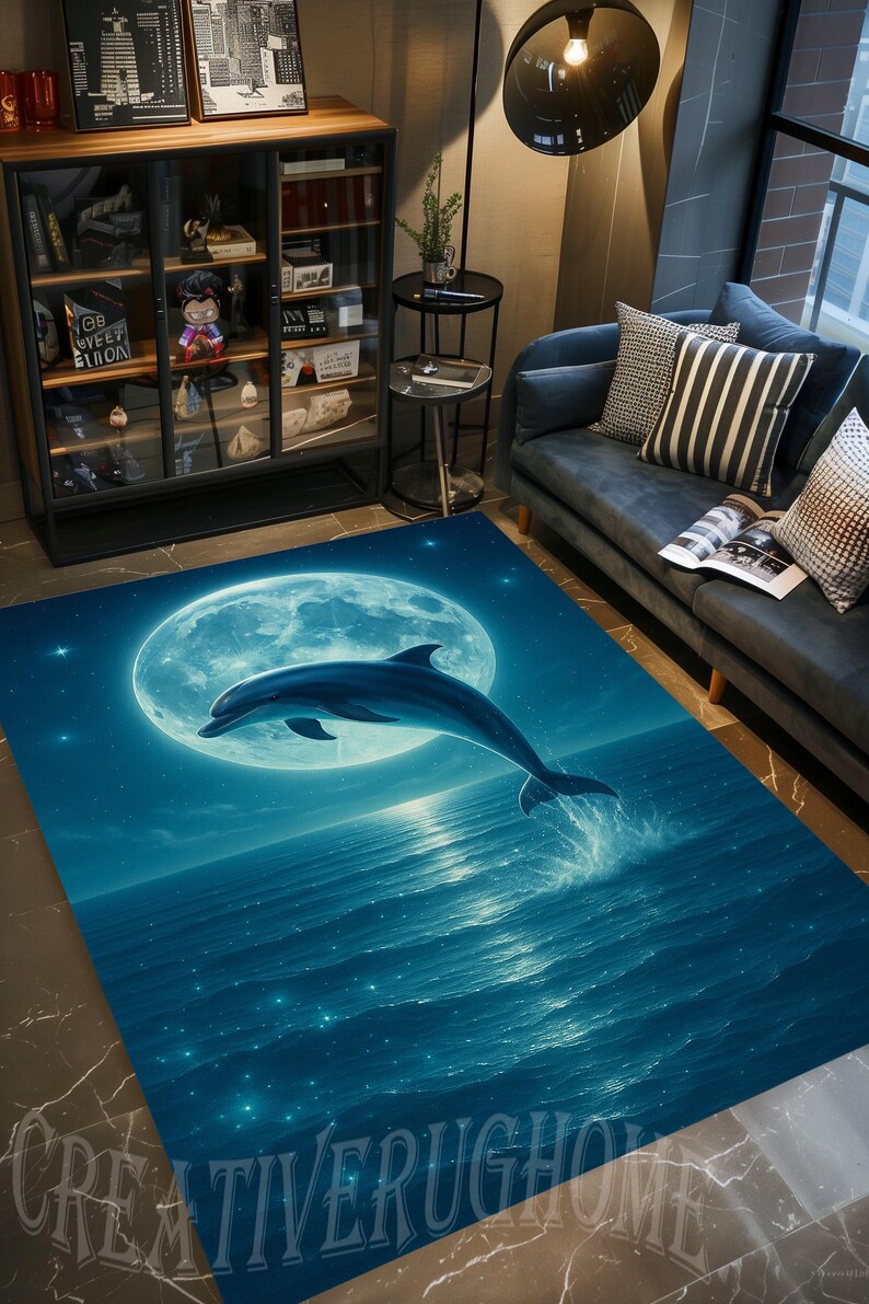 May include: A rectangular area rug featuring a dolphin leaping out of the ocean under a full moon. The rug has a blue and teal color scheme with a starry night sky design. The text "CREATIVERUGHOME" is at the bottom.