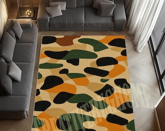 May include: A rectangular rug with a camouflage design in tan, black, orange, green, and brown. The rug is placed on a wooden floor. The pattern consists of irregular, organic shapes in various colours.
