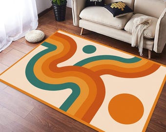 May include: A rectangular rug with a retro design. The rug has a cream background with wavy lines in orange, teal, and yellow. There is a large orange circle and a teal circle. The rug has an orange border. The rug's dimensions are approximately 150cm x 200cm.