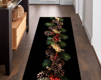 May include: A black runner rug featuring a festive design. The rug showcases a central garland of pine needles, pine cones, and red berries. The runner is designed to be placed in a hallway or entryway.