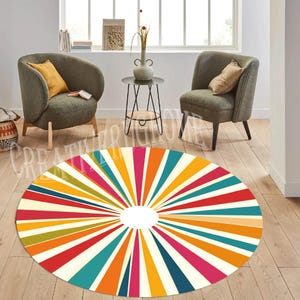 May include: A round, multi-colored area rug with a sunburst pattern. The rug has a white background with stripes of red, orange, yellow, green, blue, and pink radiating out from the center.