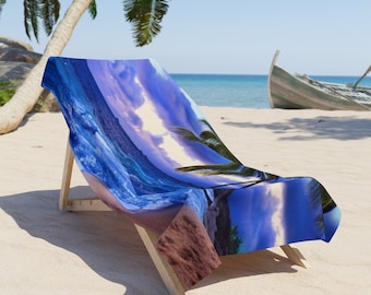 May include: A beach chair with a colorful beach scene printed on the fabric. The scene features blue ocean waves, a sandy beach, and a palm tree.