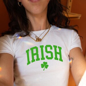 May include: White t-shirt with a green shamrock and the word "IRISH" in green letters.