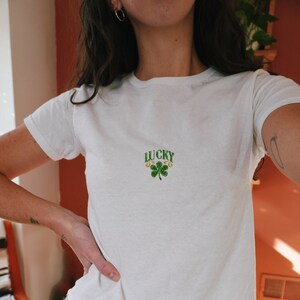Cropped Tee Shirt inspired by 90s baby tee style for women, featuring the slogan 'Lucky You' with two shamrocks, ideal for St. Patrick's Day. Targets top Google SEO rankings for girls' shirts