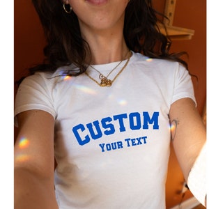 Customizable white baby tee for women with blue CUSTOM YOUR TEXT design, ready for personalized messaging,Custom Women's Fitted Tee, Custom Text Baby Tee, Custom Text Shirt, Personalized Shirt, Gift for her, Y2K Baby Tee, Retro 90s Style Tee