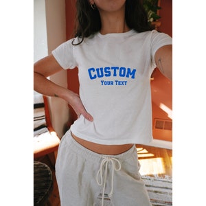 Customizable white baby tee for women with blue CUSTOM YOUR TEXT design, ready for personalized messaging,Custom Women's Fitted Tee, Custom Text Baby Tee, Custom Text Shirt, Personalized Shirt, Gift for her, Y2K Baby Tee, Retro 90s Style Tee