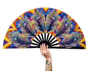 May include: A colorful hand fan with a peacock feather design and a black and white bamboo frame. The fan is open and held by a hand with tattoos.