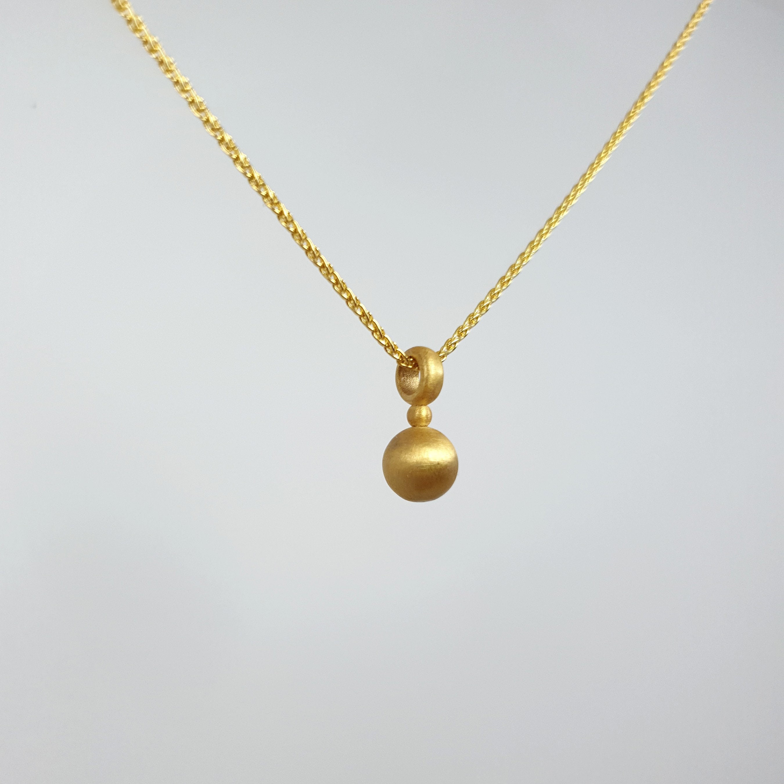 Gold ball deals locket pendant