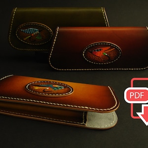 May include: Three leather cases in shades of brown and green, each featuring an oval emblem with a detailed fly fishing lure design. The cases have white stitching and a PDF icon with a download arrow.