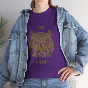 May include: Purple t-shirt with a gold owl graphic and the text "Owl's Wisdom".