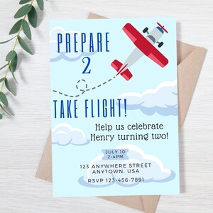 May include: A blue and white invitation with a red airplane flying through clouds. The invitation says "Prepare 2 Take Flight!" and is for a birthday party celebrating a child turning two. The invitation includes the date, time, address, and RSVP information.