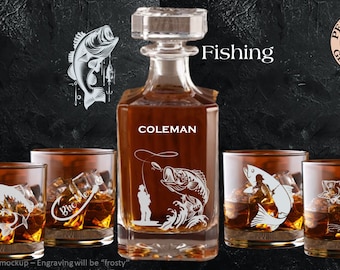 May include: A set of four personalized whiskey glasses and a decanter with a fishing theme. The glasses and decanter are engraved with a fisherman and a fish. The decanter is labeled "Coleman".