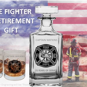 May include: A personalized decanter and two glasses with a firefighter theme. The decanter and glasses are engraved with the text "Captain Watkins" and a firefighter logo. The decanter also has the text "Fire Dept. 25 Years of Service".