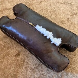 Back side of handmade leather camel stool cushion showing zipper closure, soft padding, and quality finishing for easy use and long-lasting comfort.