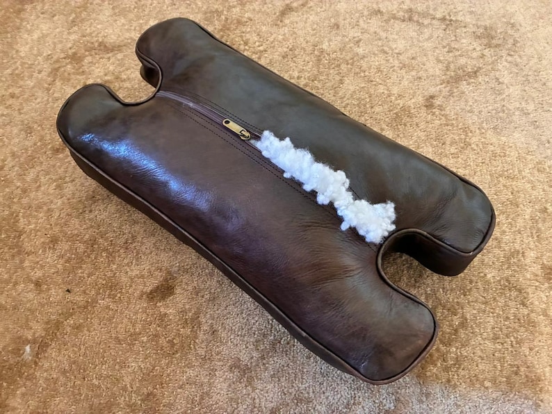 Back side of handmade leather camel stool cushion showing zipper closure, soft padding, and quality finishing for easy use and long-lasting comfort.