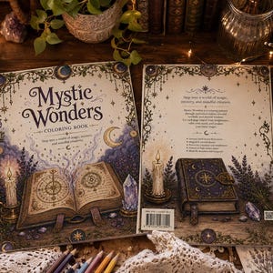May include: The Mystic Wonders coloring book features a cream-colored cover with an illustration of an open spellbook, a lit candle, and a crystal. The back cover displays a closed book, text, and a barcode, all framed by celestial motifs.