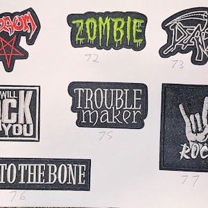 May include: Seven embroidered iron-on patches with various designs, including "Venom", "Zombie", "Death", "We Will Rock You", "Trouble Maker", "Rock", and "Bad to the Bone".