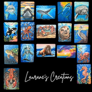 May include: A collection of rectangular art prints featuring various marine animals including dolphins, whales, sharks, manatees, octopuses, crabs, seals, pelicans, sea turtles, walruses, lobsters, and seahorses, with the text Laurane's Creations.
