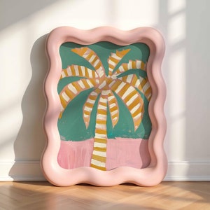 May include: A pink wavy framed picture with a painting of a yellow and white striped palm tree on a green background.