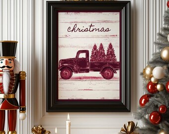 May include: A framed wall art print featuring a dark red vintage pickup truck carrying three pine trees against a white wood-plank background. The word christmas is written in a dark red cursive script above the truck illustration.